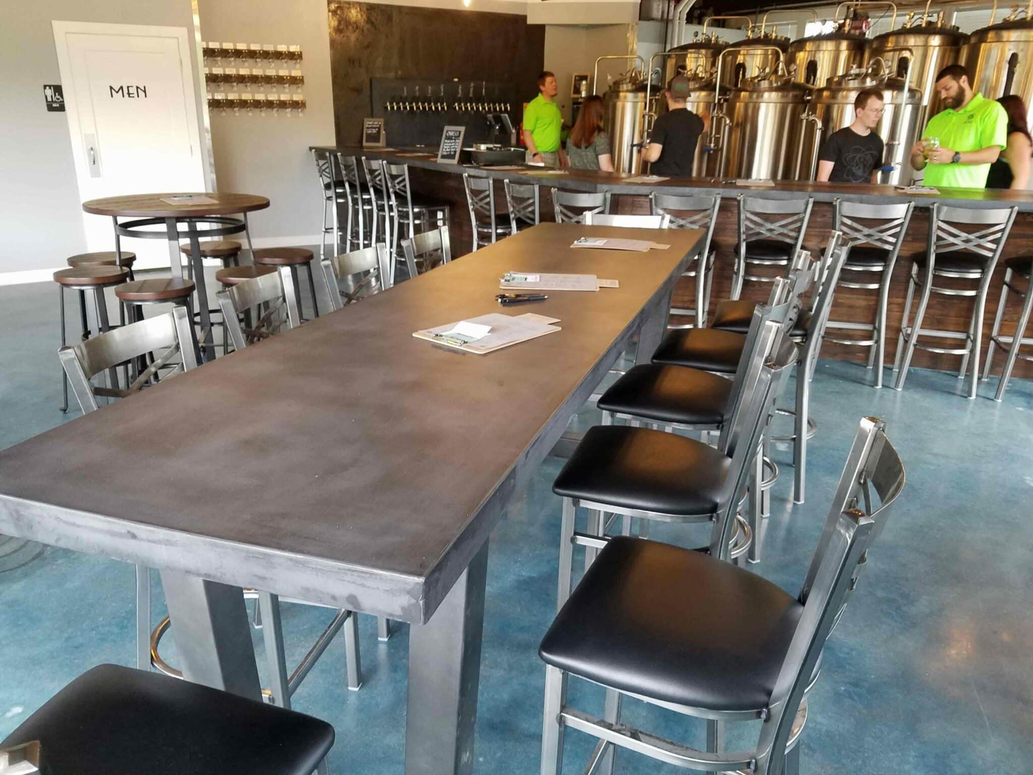 gray concrete table and bar in brewery restaurant